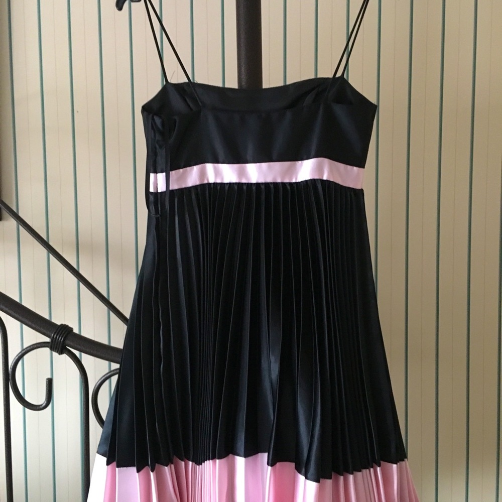 Mini prom dress. Size 3. Black pleated silky dress adorned with a  pink bow.